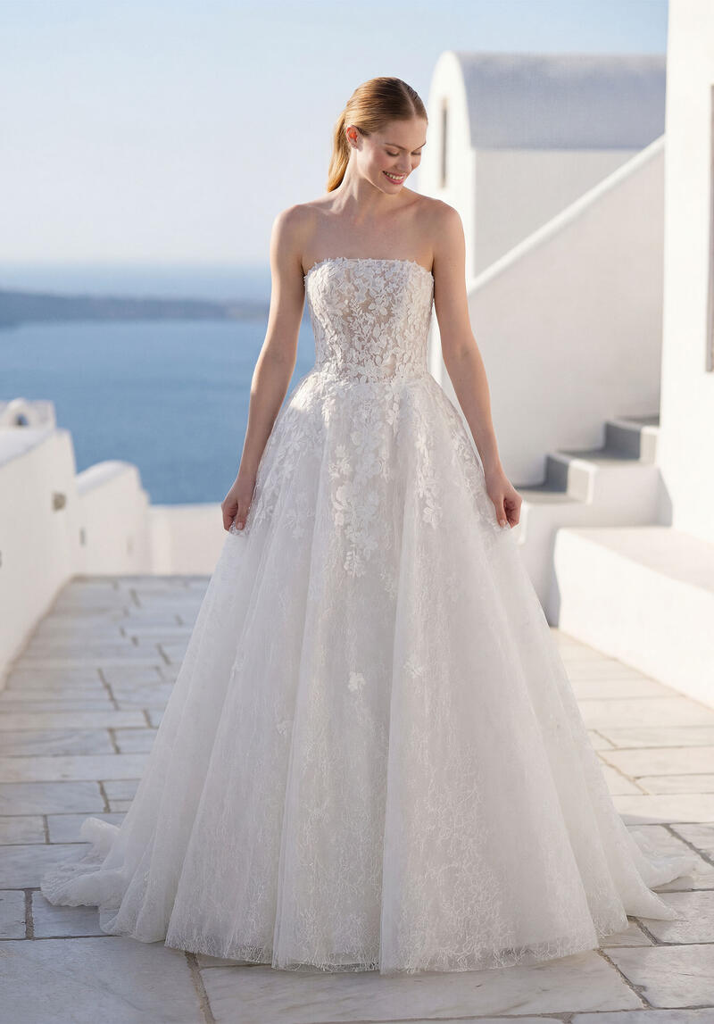 The same Morilee lace ball gown, full length, on a whitewashed terrace
