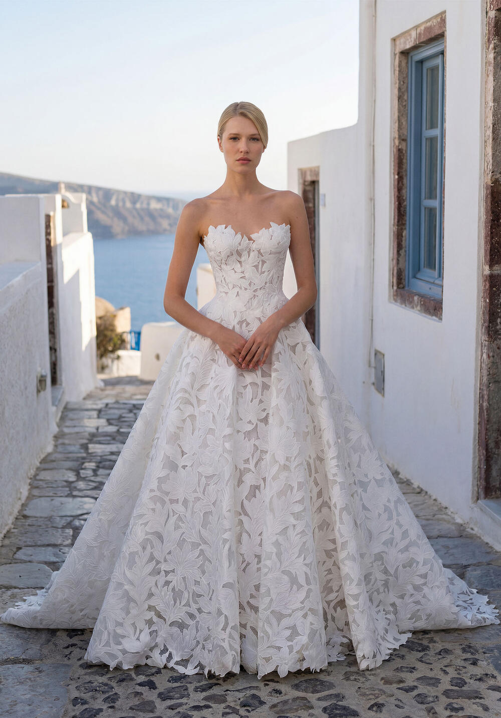 Morilee strapless A-line gown in leaf lace on a cobblestone lane