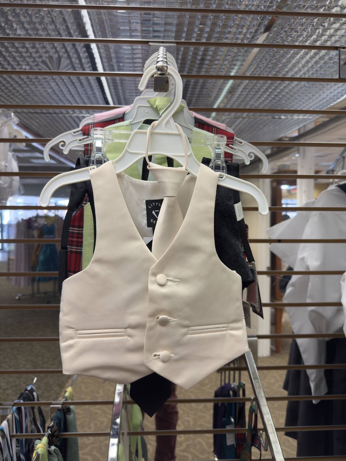 Boys' ivory vest and bow tie on a hanger
