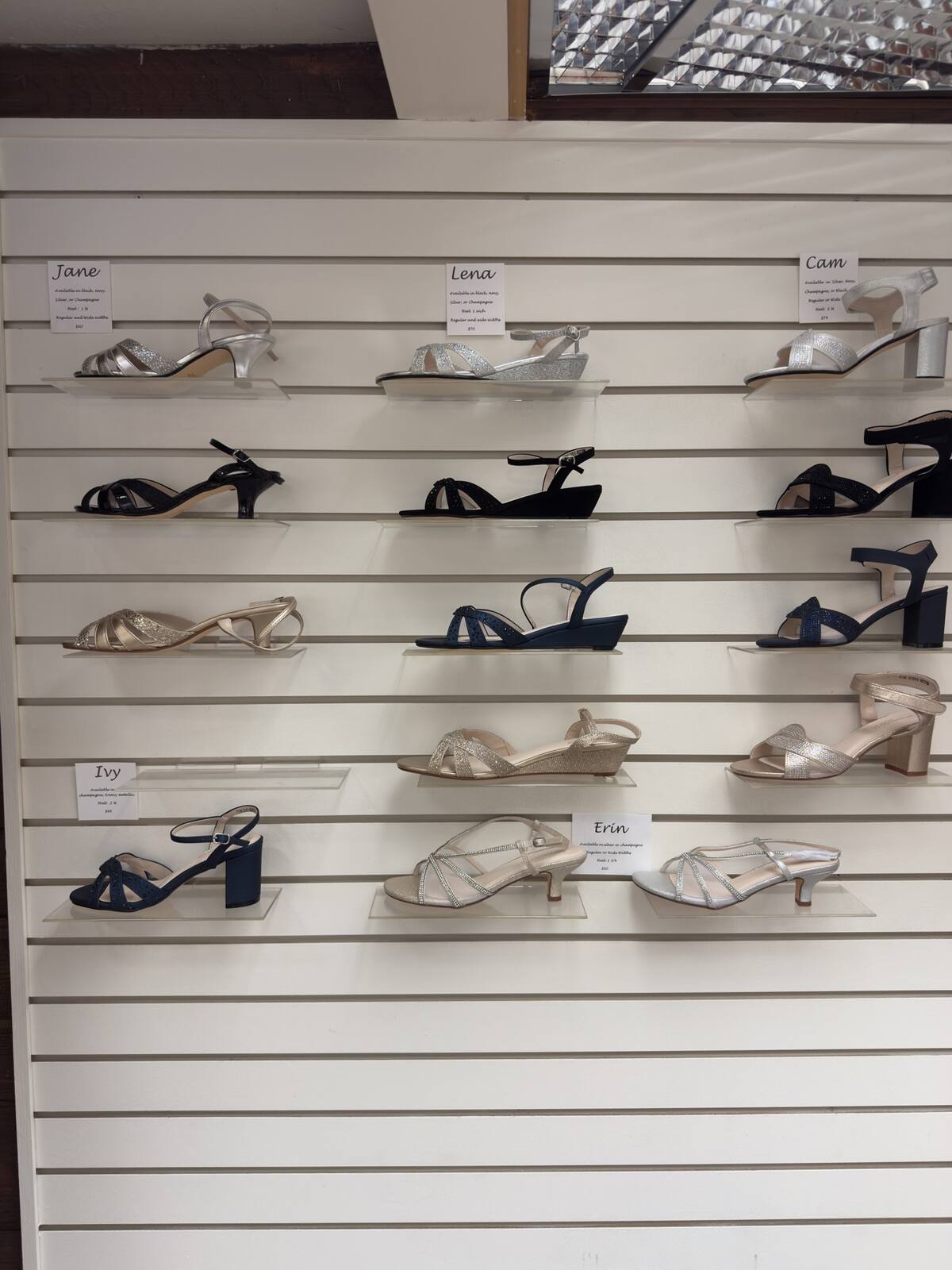 Wall of dress sandals in silver, ivory, and navy