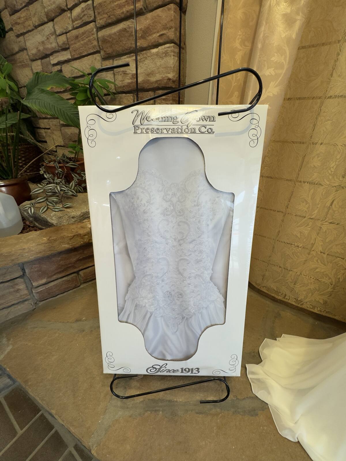 A wedding gown boxed in a Wedding Gown Preservation Co. chest