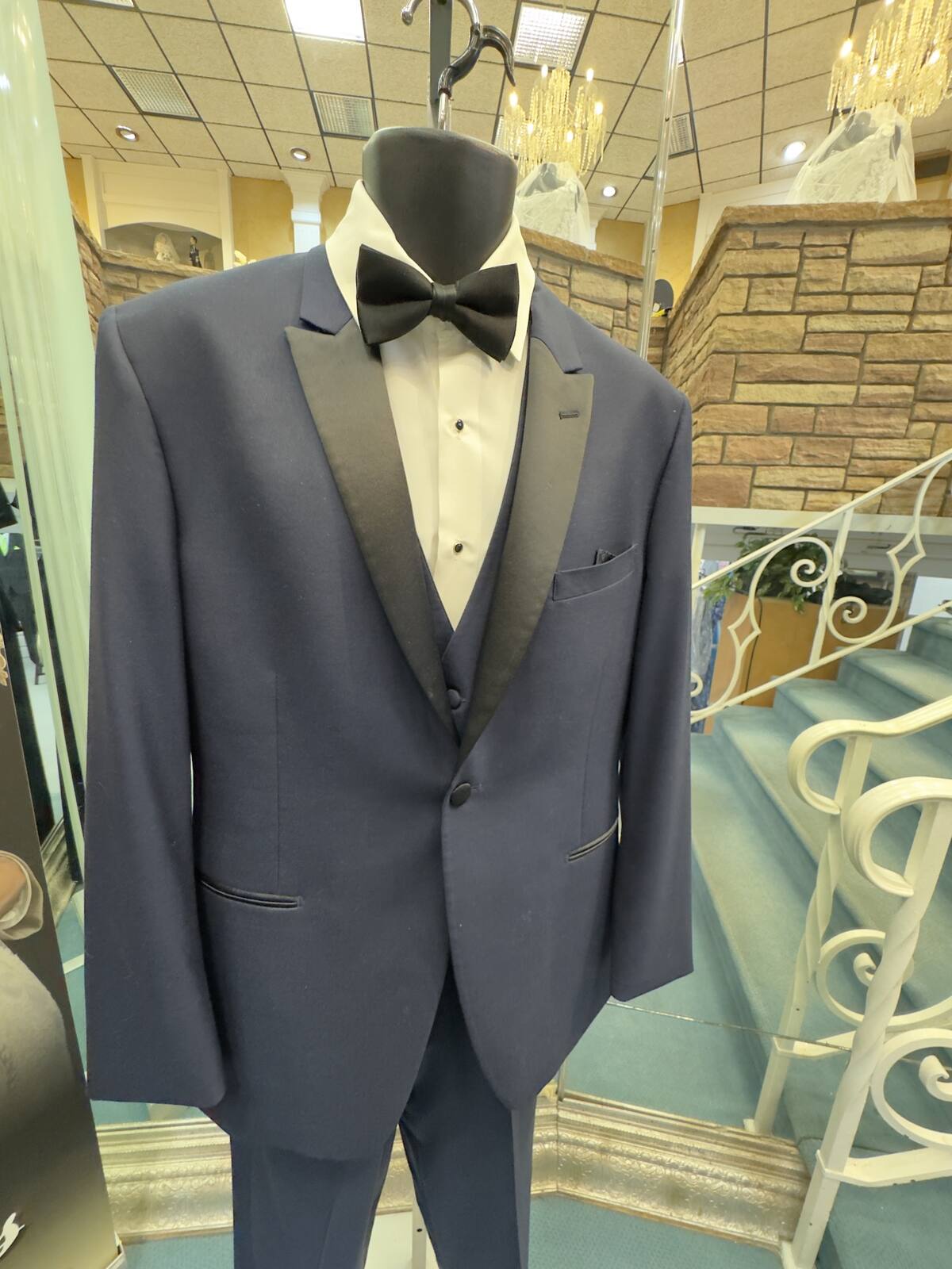 Slate blue tuxedo with black satin lapels and a bow tie