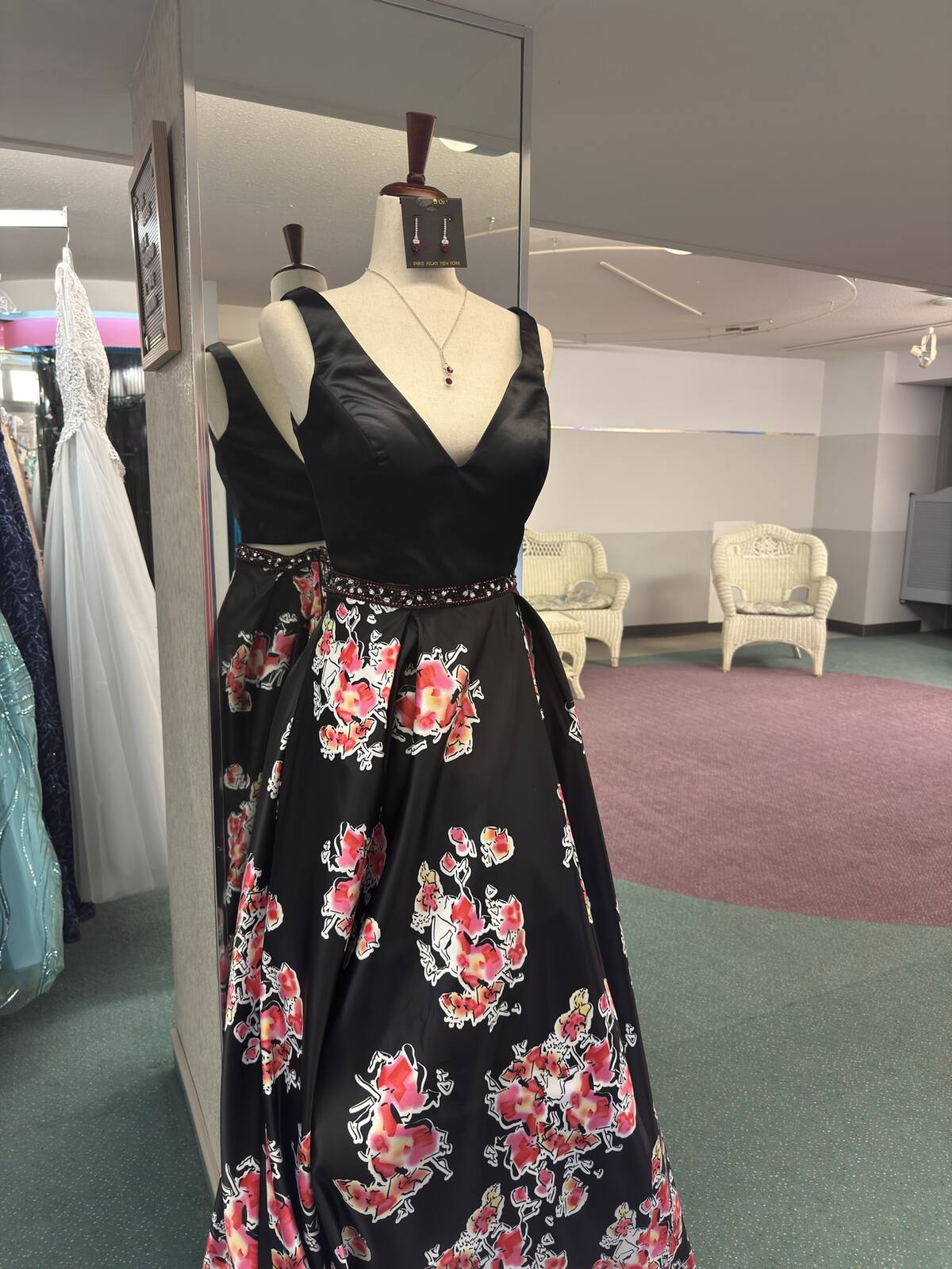 Black satin prom gown with a red and pink floral skirt