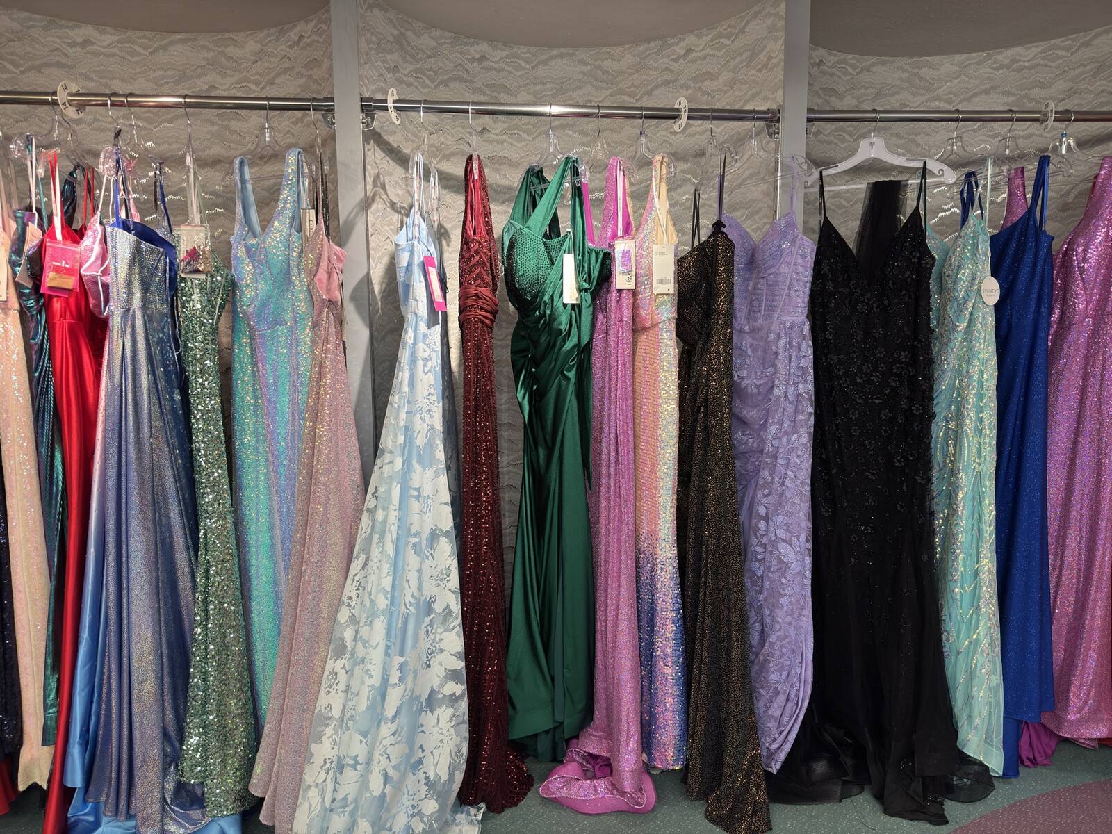 A full rack of prom dresses in every color
